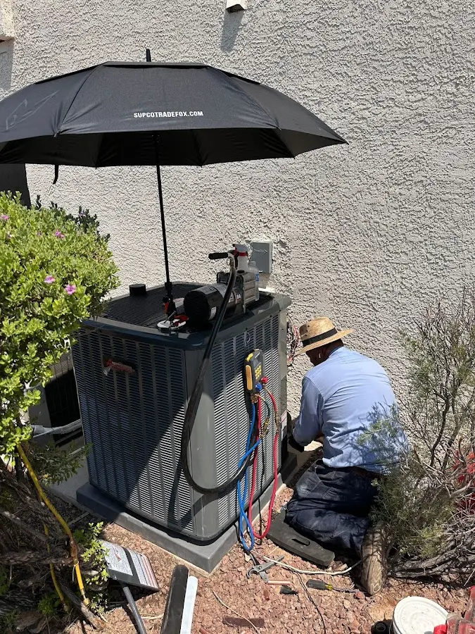 HVAC technician performing outdoor AC maintenance in Park City
